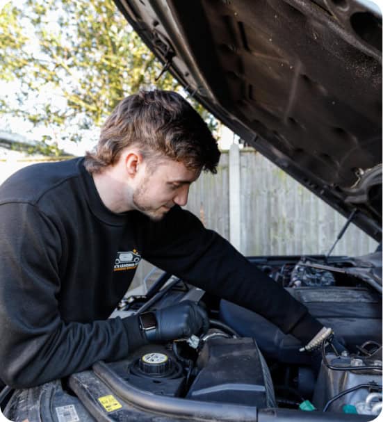 Technician performing particle filter additive service on vehicle